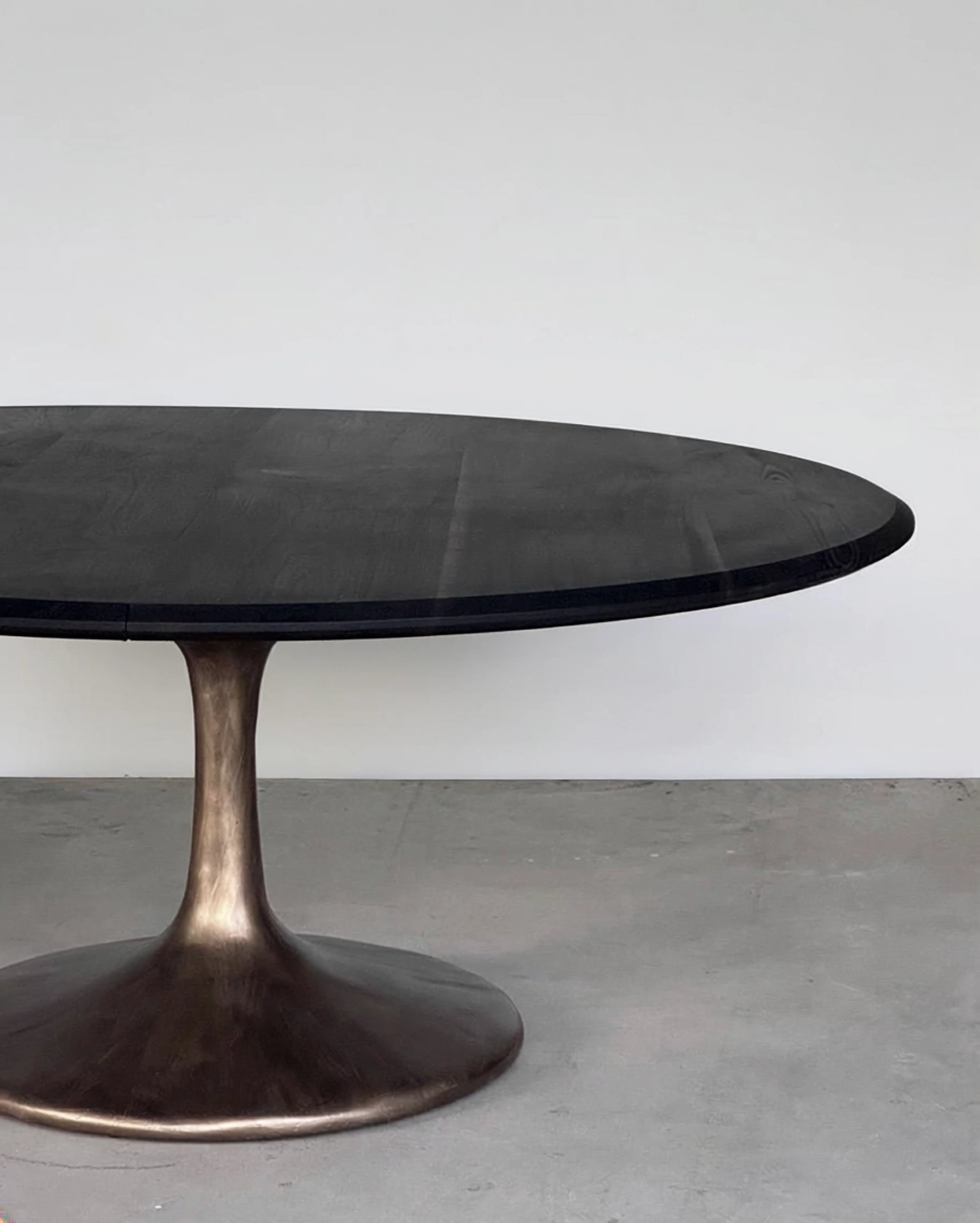 Ebonized round table on a bronze pedestal