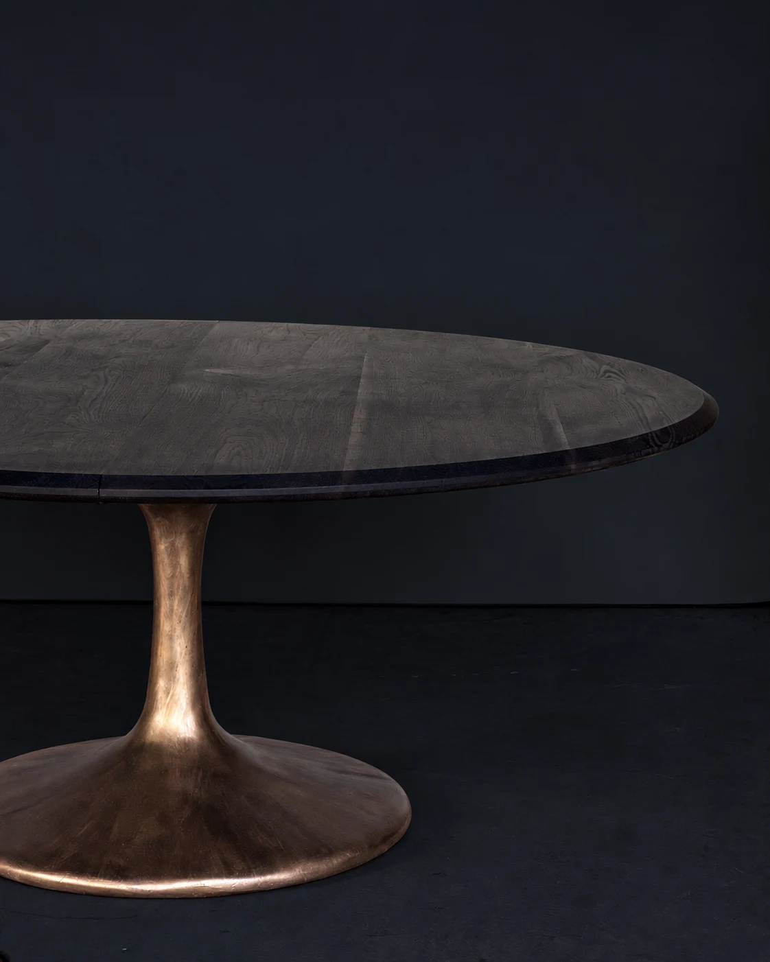 Dusk ebonized oval table on a cast bronze pedestal